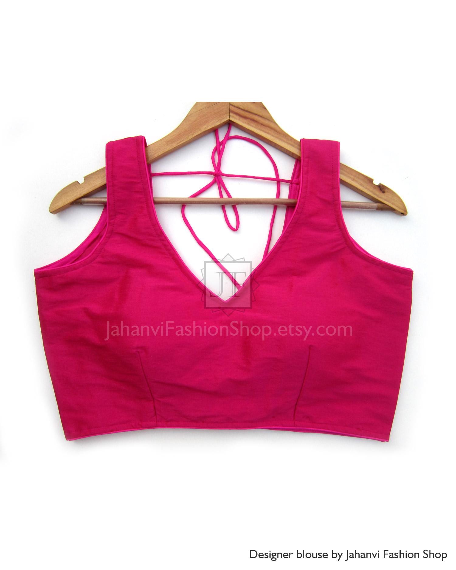Magenta sleeveless V-neck saree blouse with tie-up back on hanger