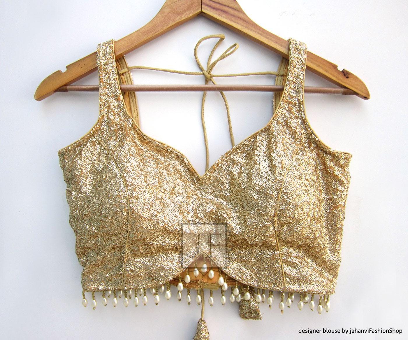 Light gold glitter sequin sleeveless saree blouse with V neckline and short fringe trim