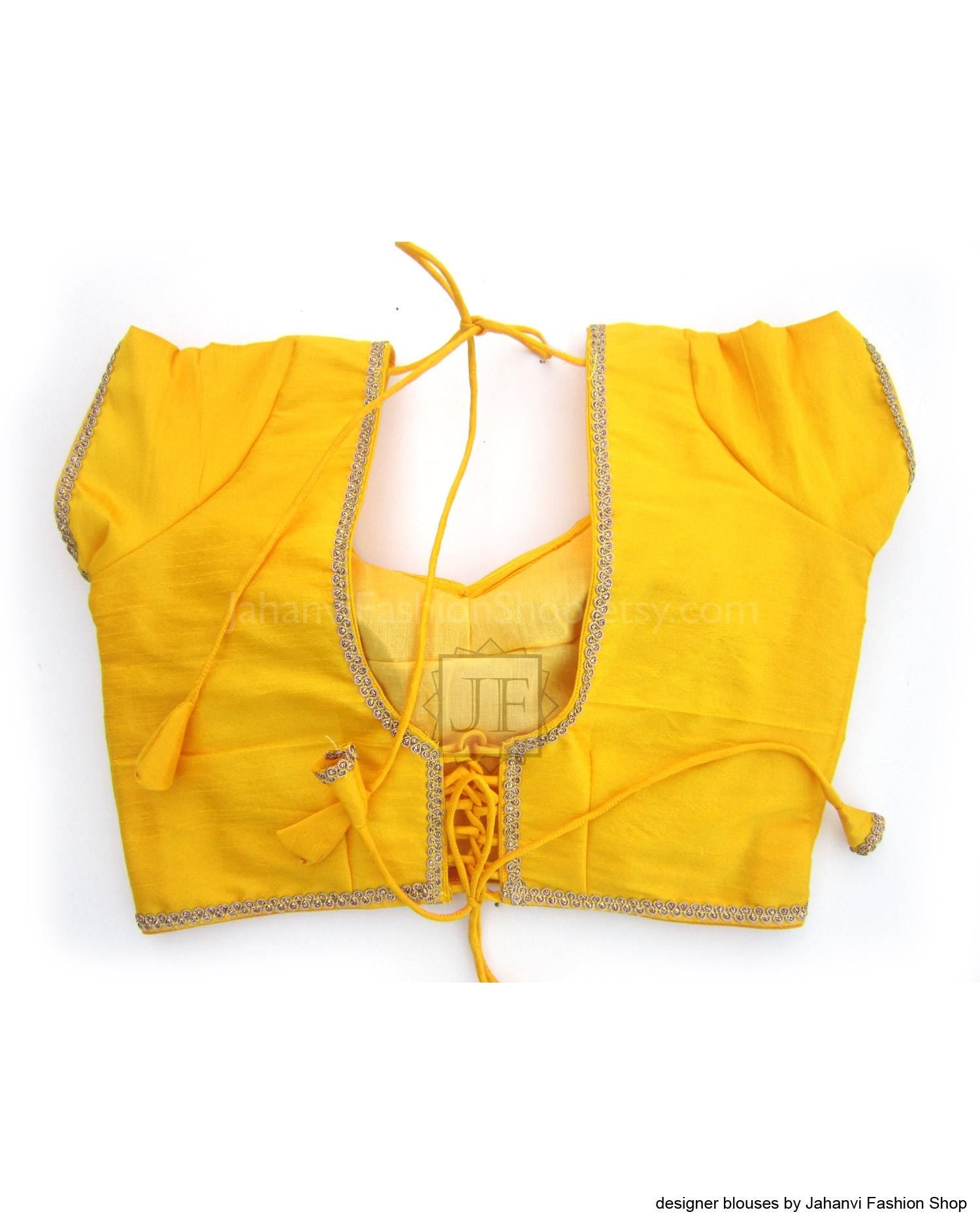 Yellow saree blouse crop top with back open scalloped neckline and golden trim, tie laces