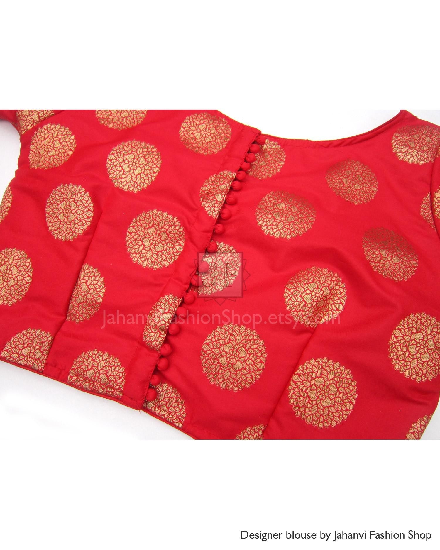 Red boat-neck brocade saree blouse front with gold circular pattern and center placket.