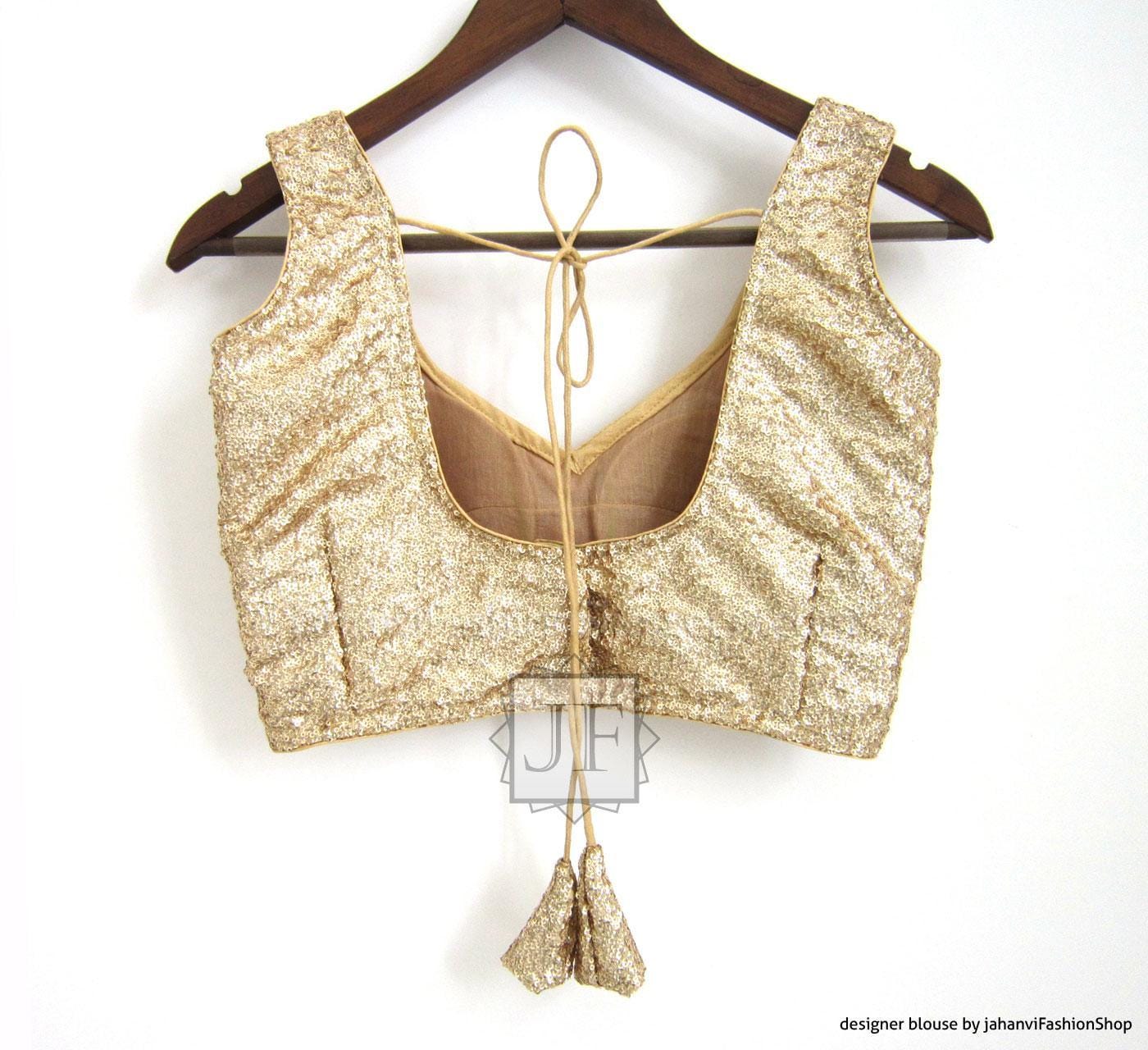 Gold sequin saree blouse top with scooped back, drawstring tie, and hanging tassel
