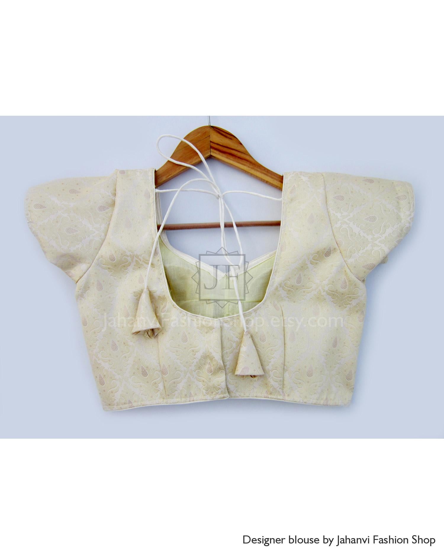 Cream gold short-sleeve saree blouse back with V neckline and stitched motif