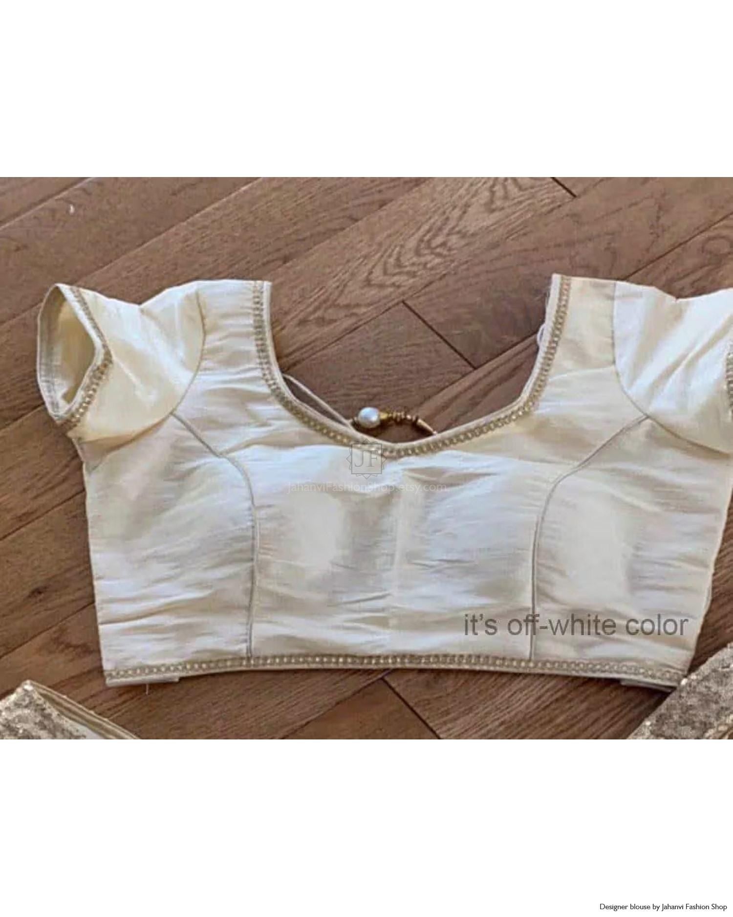 Off-white raw silk crop blouse with lace-trim neckline and pearl back hook