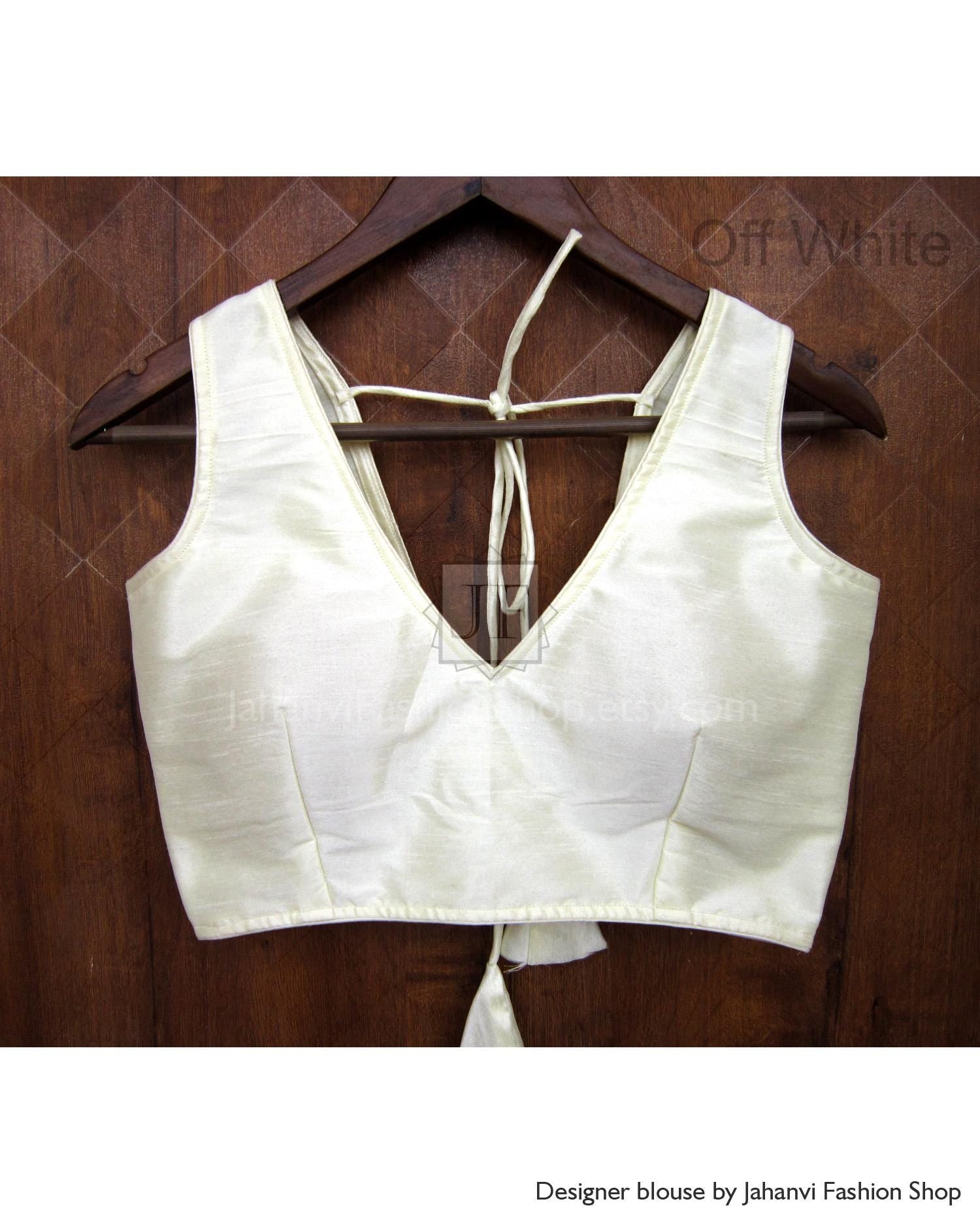Off-white deep V-neck sleeveless saree blouse with thin tie straps