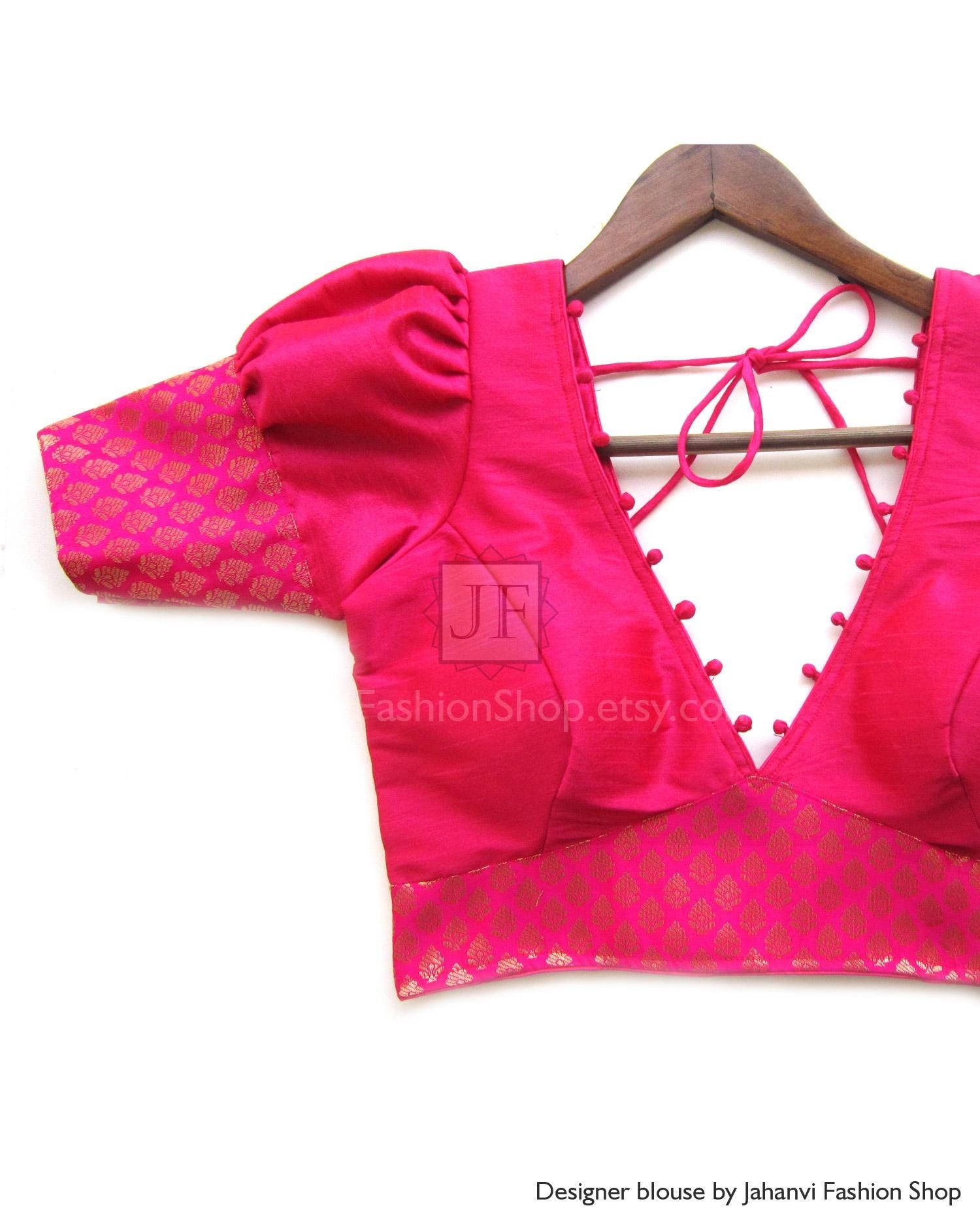 Magenta V-neck Indian saree blouse with short puff sleeves and patterned lace trim