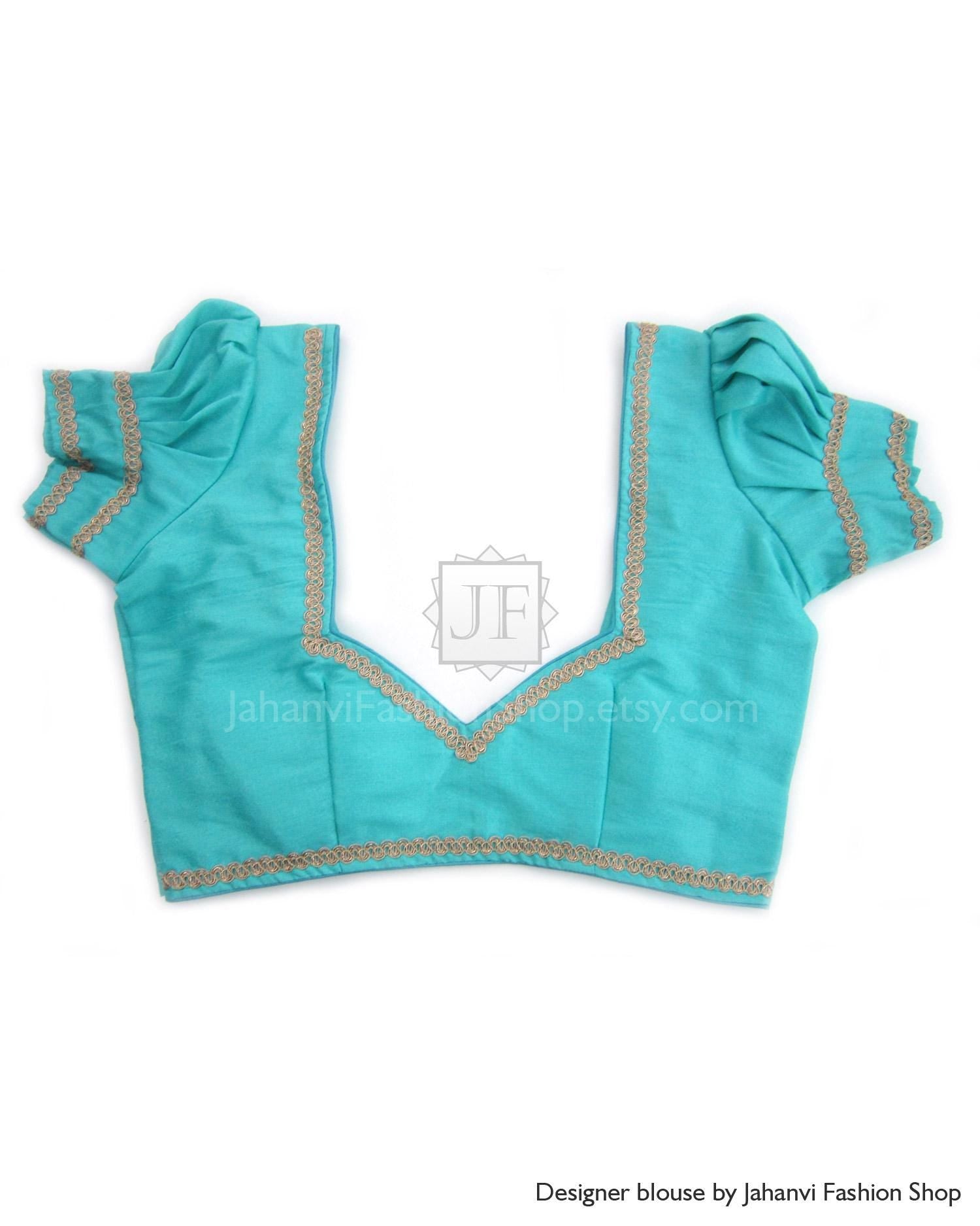 Teal puff sleeve silk saree blouse with gold trim and V-neck