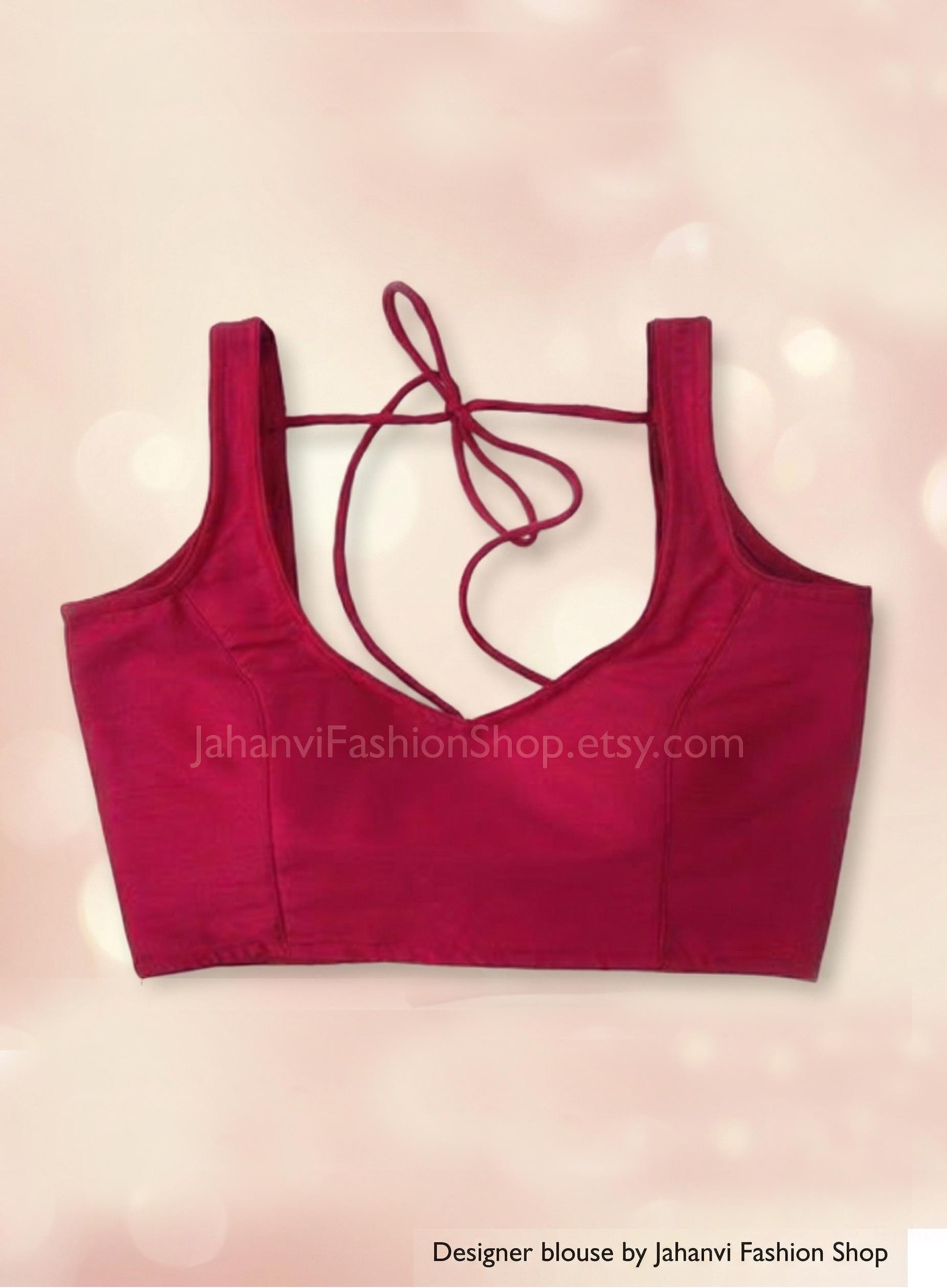 Maroon sleeveless saree blouse with wide neckline and tie-back string, simple front