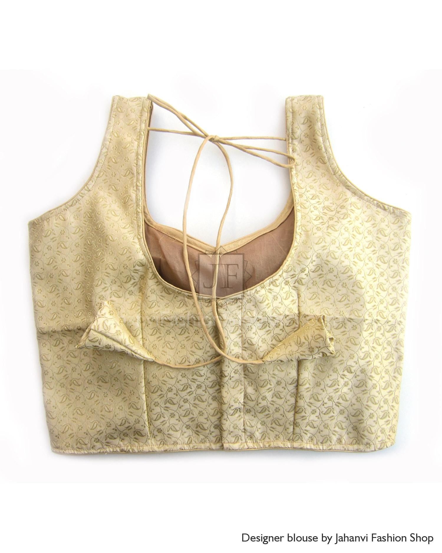 Golden sleeveless blouse with open back and crisscross tie straps, pleated front