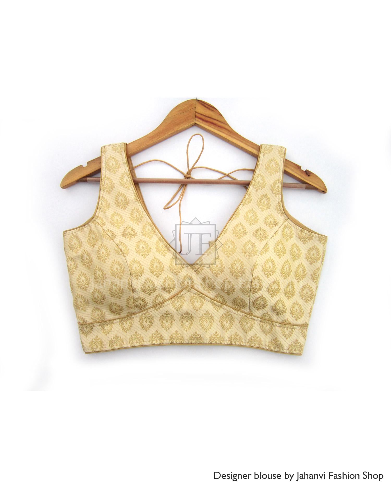 Golden brocade saree blouse with V-neck and sleeveless cut, decorative border trim