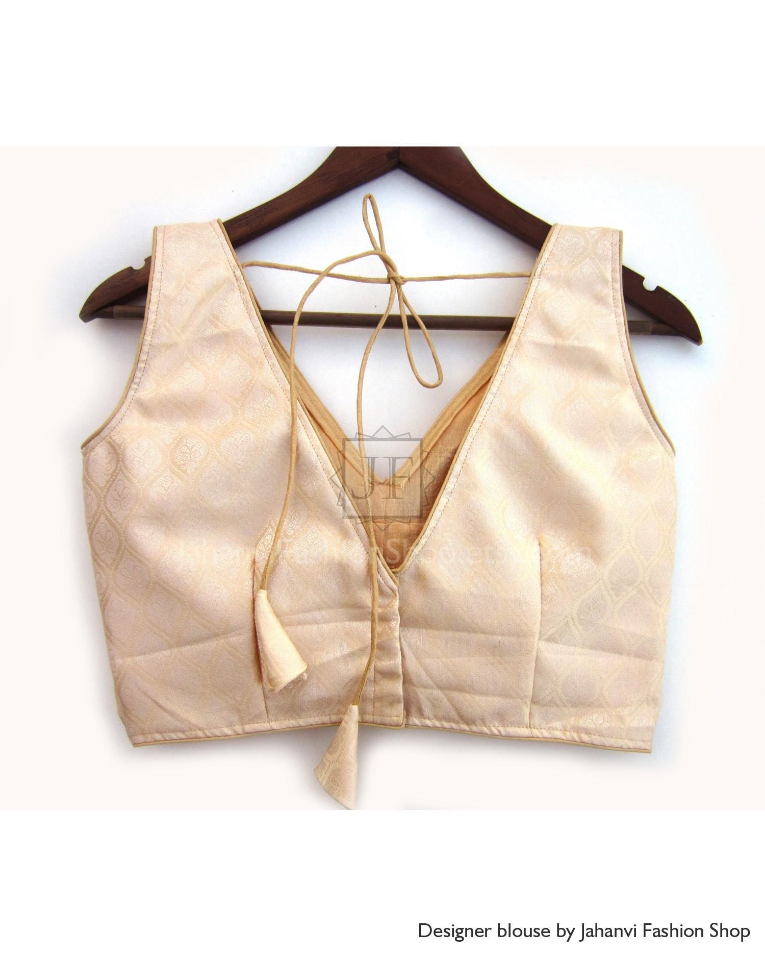 Gold-beige sleeveless saree blouse with deep V-neck and open-back tie