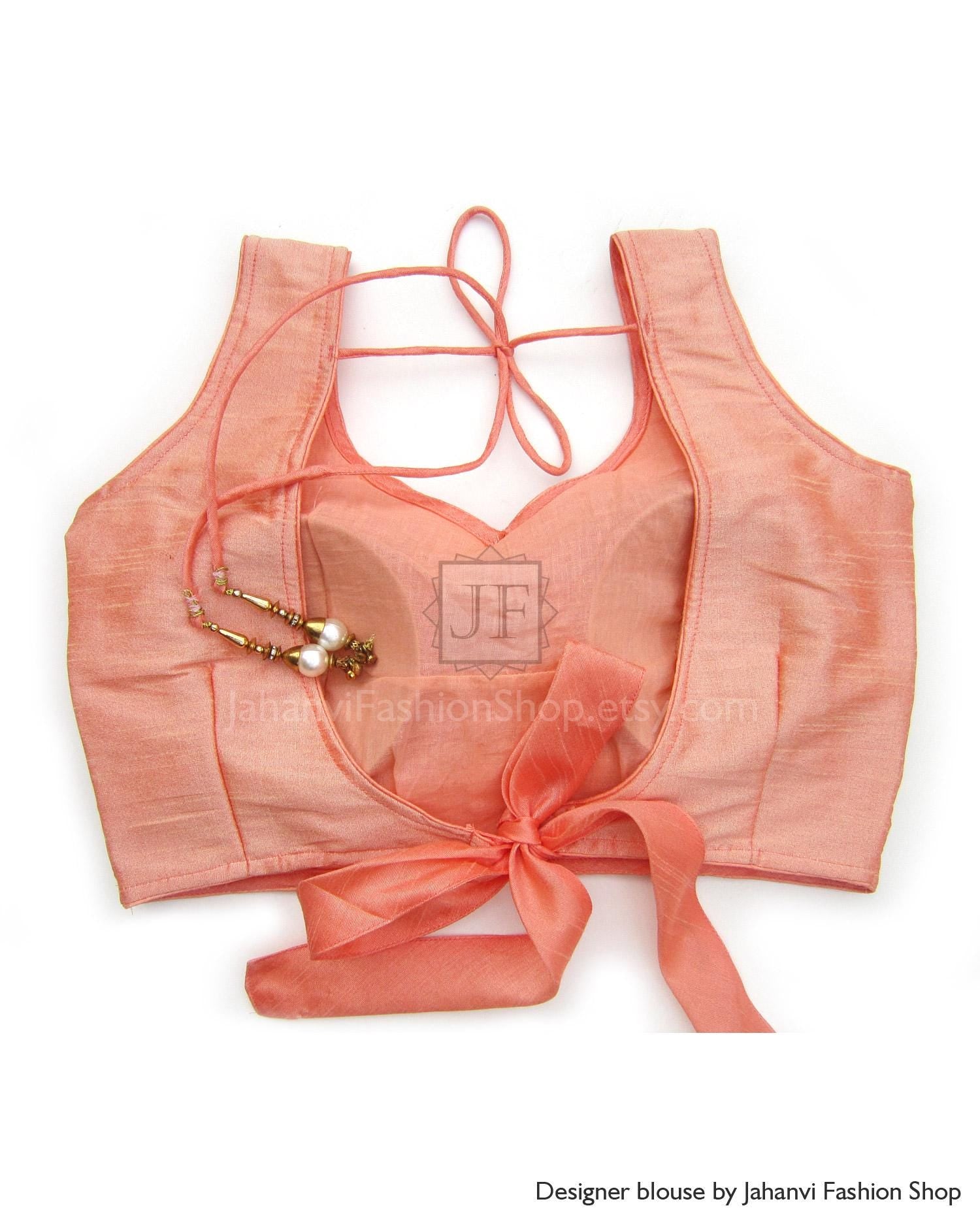 Coral pink sleeveless saree blouse with ribbon tie and V-back straps