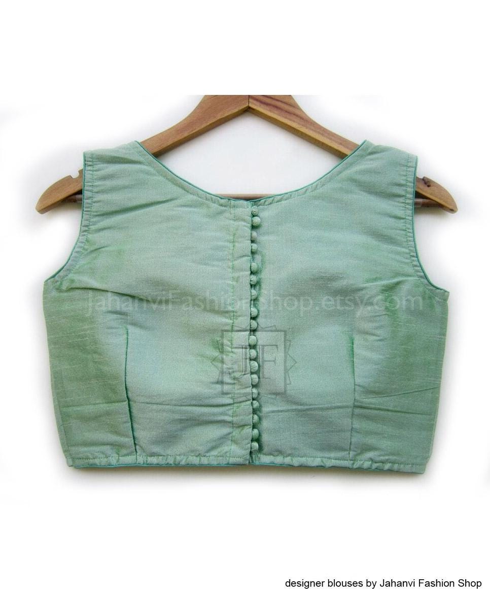 Mint green sleeveless boat-neck crop blouse with front button placket