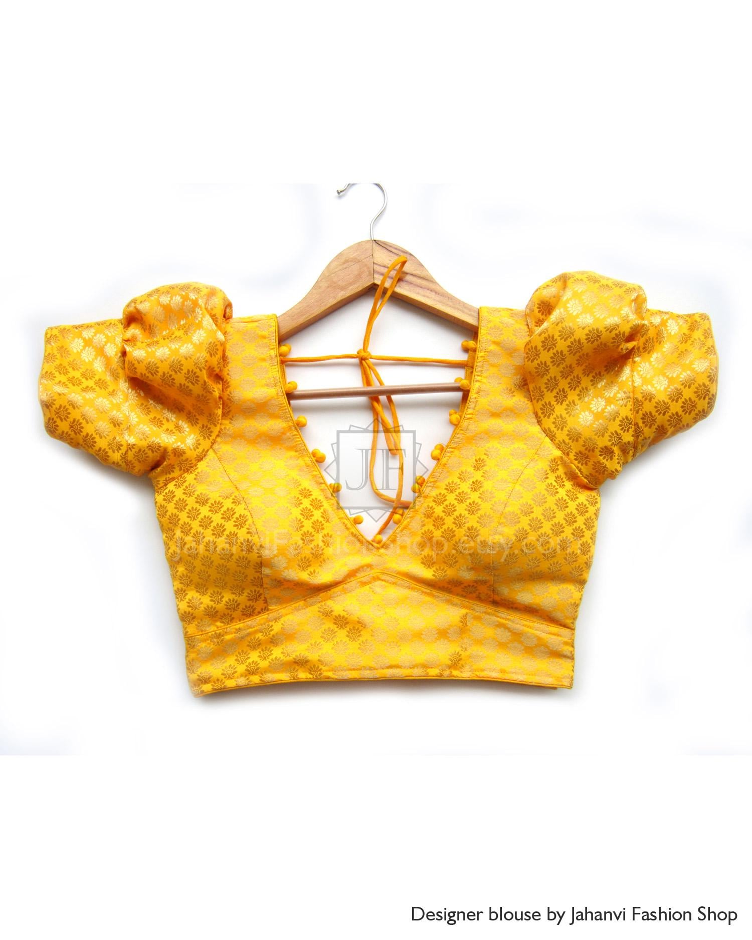 Mustard-yellow saree blouse with puff sleeves and deep V-neck, back tie strings
