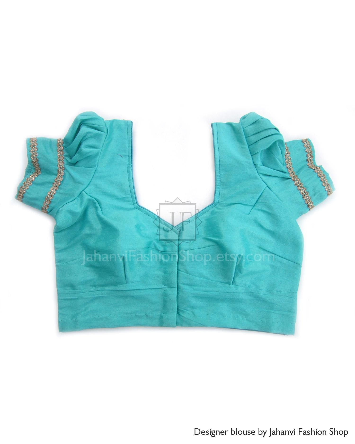 Teal puff sleeve silk saree blouse with gold-trimmed V-neck and pleated front