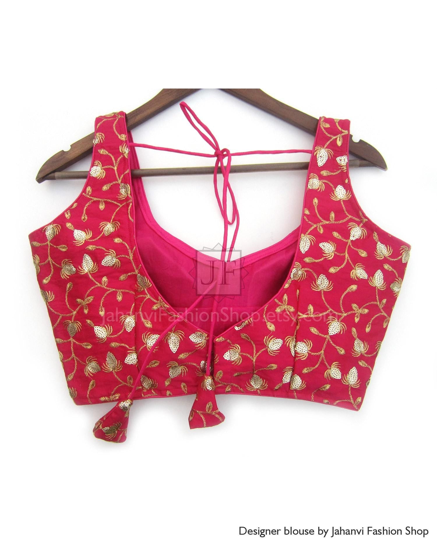 Designer saree blouse in magenta red with gold embroidered motifs and tie-back halter