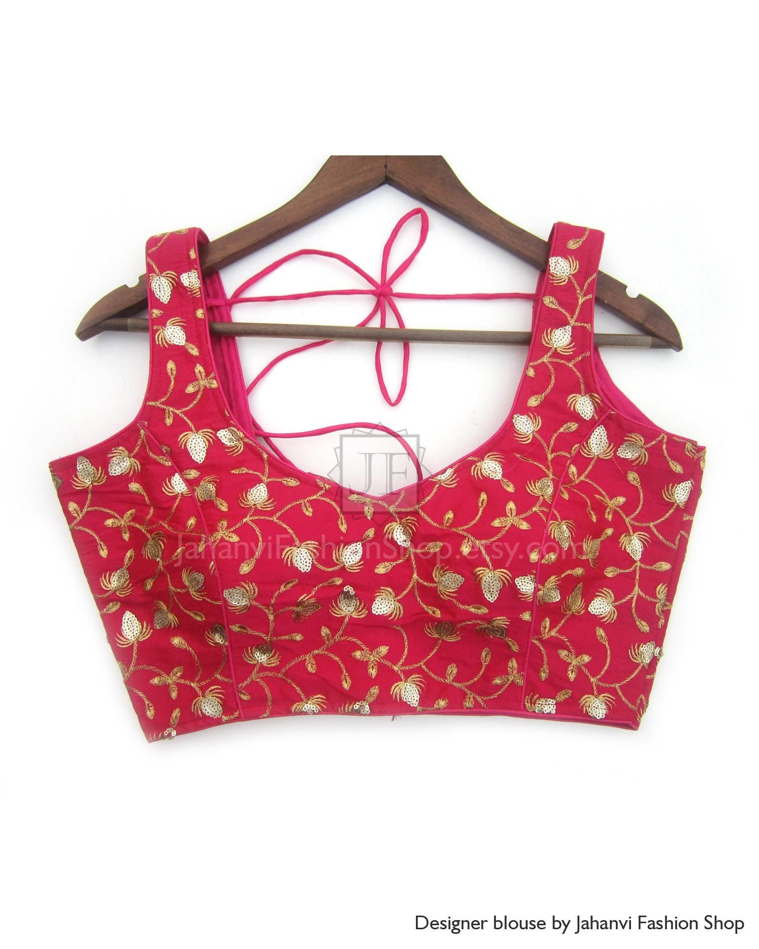 Sleeveless designer saree blouse in deep red with gold embroidered motifs, tie-back