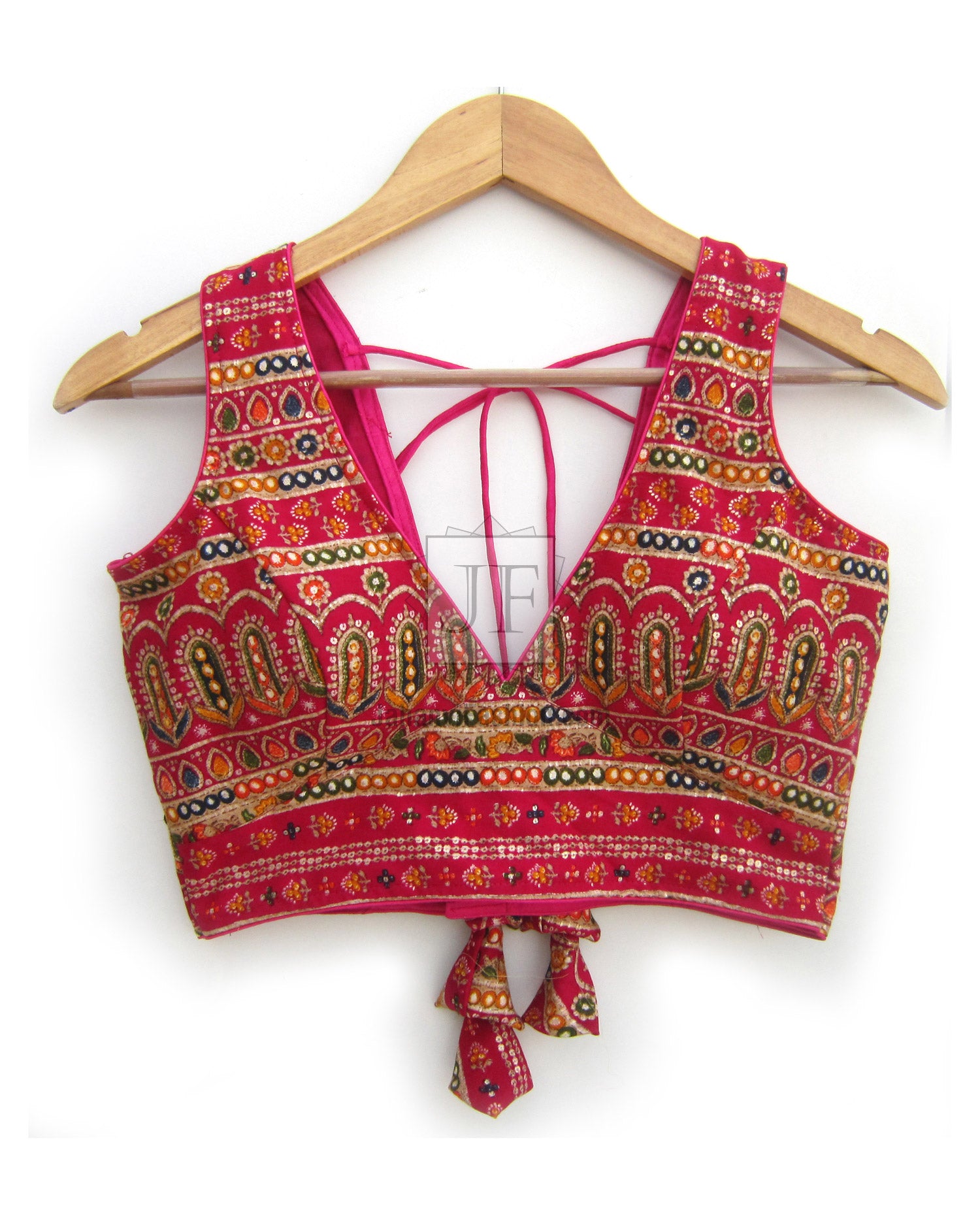 V-neck sleeveless blouse front in magenta with gold motifs, embroidered trim, tie strings